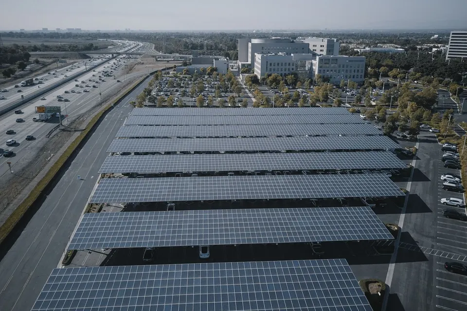 Aerial view of extensive solar panels in an urban setting, showcasing renewable energy.